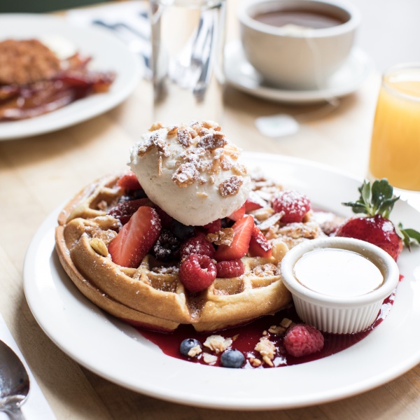 Mixed Berry Buttermilk Waffle with whipped cream and toasted almonds