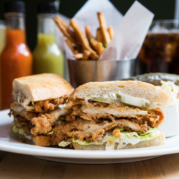 Fried Chicken Sandwich with french fries and hot sauce