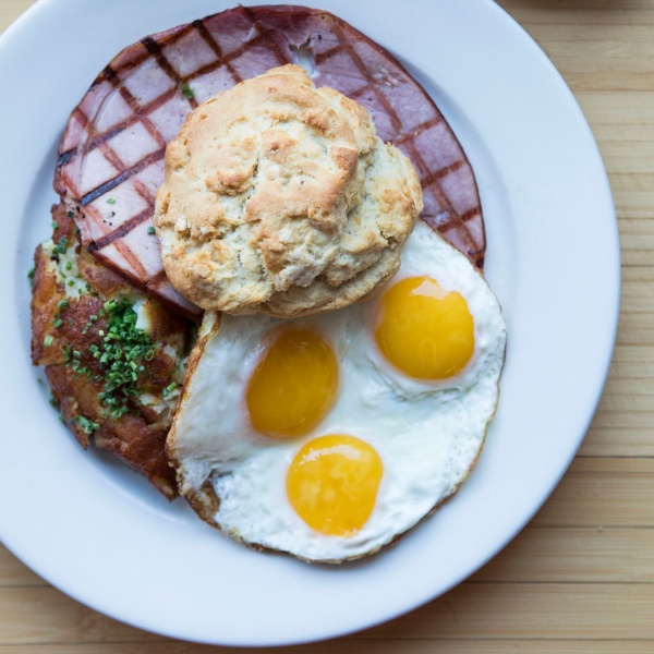 Country Breakfast with sunny side up eggs, grilled ham, hash browns, and a buttermilk biscuit